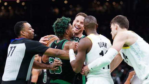 Boston Celtics forward Blake Griffin (91) and Utah Jazz guard Kris Dunn (11) have some words in the second half at TD Garden.